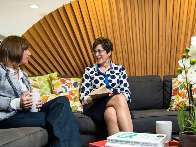 Randi in a one-to-one coaching conversation on a sofa